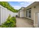 Backyard patio with privacy fence, air conditioning unit, doorway and greenery at 8313 Carob Tree Ln, Charlotte, NC 28215