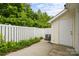Backyard patio with privacy fence, air conditioning unit and greenery at 8313 Carob Tree Ln, Charlotte, NC 28215