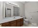 Bathroom with a vanity, large mirror, and a shower/tub at 8313 Carob Tree Ln, Charlotte, NC 28215