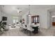 Elegant dining area featuring a marble-top table, a decorative cabinet, and easy access to the living space at 8313 Carob Tree Ln, Charlotte, NC 28215