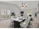 This dining room features a marble-topped table and a charming fireplace for cozy meals and gatherings at 8313 Carob Tree Ln, Charlotte, NC 28215
