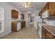 Well-lit kitchen featuring tile floors and white appliances that seamlessly transition to the living room at 8313 Carob Tree Ln, Charlotte, NC 28215