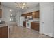 Kitchen featuring tile floors, wood cabinets, and white appliances at 8313 Carob Tree Ln, Charlotte, NC 28215