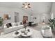 Bright living room featuring elegant furniture, a ceiling fan, and an open dining area for entertaining at 8313 Carob Tree Ln, Charlotte, NC 28215