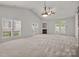 Spacious living room with vaulted ceilings, fireplace, and ample natural light at 8313 Carob Tree Ln, Charlotte, NC 28215