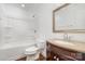 Bright bathroom features tub and shower combination and vanity with granite countertop at 8325 Knights Bridge Rd, Charlotte, NC 28210