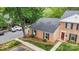 Brick exterior of townhome with neat landscaping and a convenient parking area at 8325 Knights Bridge Rd, Charlotte, NC 28210