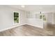Bright living room featuring wood-look floors and modern lighting at 8325 Knights Bridge Rd, Charlotte, NC 28210