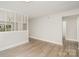 Spacious living room with wood-look floors and decorative room divider at 8325 Knights Bridge Rd, Charlotte, NC 28210