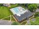 Aerial view of a community pool surrounded by lush landscaping, lounge chairs, and umbrellas at 8325 Knights Bridge Rd, Charlotte, NC 28210
