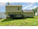 View of the home's rear exterior with a wooden deck, siding, and a well-maintained lawn at 8509 Sienna Dr, Charlotte, NC 28215