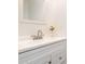 Bathroom vanity with a white countertop, brushed nickel faucet, framed mirror and wall decor at 8509 Sienna Dr, Charlotte, NC 28215