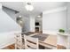 Elegant dining room with modern lighting, neutral paint, and views into the living room area at 8509 Sienna Dr, Charlotte, NC 28215