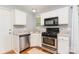 Bright kitchen with stainless steel appliances, countertops and hardwood flooring at 8509 Sienna Dr, Charlotte, NC 28215