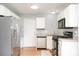 Well-lit kitchen featuring stainless steel appliances, granite countertops, and white cabinets at 8509 Sienna Dr, Charlotte, NC 28215