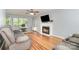 Relaxing living room featuring a fireplace, comfortable seating, and bright natural light from large windows at 8509 Sienna Dr, Charlotte, NC 28215