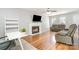 Inviting living room with a cozy fireplace, hardwood floors, plush seating, and a ceiling fan at 8509 Sienna Dr, Charlotte, NC 28215