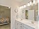 Bright bathroom features double sink vanity and clocks as decorations and is connected to the main bedroom at 876 Hardin St # B24, Lancaster, SC 29720