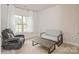 Bedroom featuring neutral colored carpet, gray couch, and gray recliner with a wooden coffee table at 876 Hardin St # B24, Lancaster, SC 29720