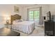 Bedroom with carpet, light pink bedding, light colored curtains, and a TV atop a black dresser at 876 Hardin St # B24, Lancaster, SC 29720