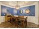 Elegant dining room with blue accent wall, wainscoting and modern chandelier at 876 Hardin St # B24, Lancaster, SC 29720