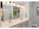 Bathroom featuring a dual vanity, modern lighting, and neutral color scheme at 876 Hardin St # B24, Lancaster, SC 29720
