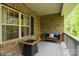 Covered porch boasts brick siding, and a cozy seating area, perfect for relaxation and outdoor enjoyment at 876 Hardin St # B24, Lancaster, SC 29720
