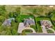 Aerial view of landscaped home with pool and manicured lawn surrounded by lush greenery and a circular driveway at 89 Wexford Pt, Hickory, NC 28601