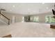 Expansive basement with stair access, carpet floors, and multiple doors to the exterior at 89 Wexford Pt, Hickory, NC 28601