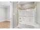 Bathroom with tiled shower and glass doors, with light tile flooring at 89 Wexford Pt, Hickory, NC 28601