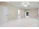 Spacious bedroom with neutral walls, white carpet, and a view into an adjoining room with a stone fireplace at 89 Wexford Pt, Hickory, NC 28601