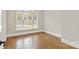 Sunlit bedroom with hardwood floors, large window, and neutral color palette at 89 Wexford Pt, Hickory, NC 28601