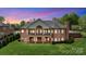 Back of a two-story brick house with a large yard and multiple covered patios at 89 Wexford Pt, Hickory, NC 28601