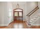 Bright foyer with hardwood floors, a staircase, and a decorative chandelier at 89 Wexford Pt, Hickory, NC 28601