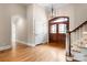 Elegant foyer featuring hardwood floors, a staircase, and a wooden front door at 89 Wexford Pt, Hickory, NC 28601