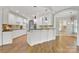 A lovely kitchen has granite countertops, stainless appliances, white cabinetry and hardwood flooring at 89 Wexford Pt, Hickory, NC 28601