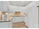 Bright kitchen showcasing white cabinetry, granite countertops, and modern appliances at 89 Wexford Pt, Hickory, NC 28601