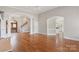 Open-concept living room featuring hardwood floors, arched doorways, and neutral paint at 89 Wexford Pt, Hickory, NC 28601