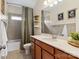 Well-lit bathroom featuring a shower-tub combo, decorative shelves, and framed wall art at 962 Herrons Ferry Rd, Rock Hill, SC 29730