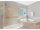 Modern bathroom with a glass shower and a luxurious soaking tub next to a window at 962 Herrons Ferry Rd, Rock Hill, SC 29730