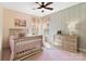 Bright bedroom features a ceiling fan, soft pink accents, and natural light from two windows at 962 Herrons Ferry Rd, Rock Hill, SC 29730