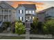 Charming blue two-story home with landscaped front yard and inviting front porch with sunset skies in the background at 962 Herrons Ferry Rd, Rock Hill, SC 29730