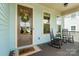 Inviting front porch with rocking chairs, decorative wreath, and welcome mat on a charming blue home at 962 Herrons Ferry Rd, Rock Hill, SC 29730