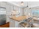 Kitchen with stone countertops and breakfast bar with bright eating nook in the background at 962 Herrons Ferry Rd, Rock Hill, SC 29730