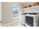 Bright laundry room with modern washer and dryer, white cabinets, and natural light at 962 Herrons Ferry Rd, Rock Hill, SC 29730