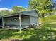 Rear view of a cozy home with a covered back porch, showing the siding and surrounding greenery at , Salisbury, NC 28147