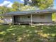 Exterior view of a home featuring a covered back porch and a spacious backyard on a sunny day at , Salisbury, NC 28147