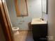 Bathroom with a black vanity sink, toilet, and a window at , Salisbury, NC 28147
