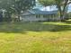 A quaint single-story home with a metal roof sits on a large, grassy lot shaded by mature trees at , Salisbury, NC 28147