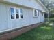 View of the exterior showing a white siding wall, multiple windows, and a brick planter box at , Salisbury, NC 28147